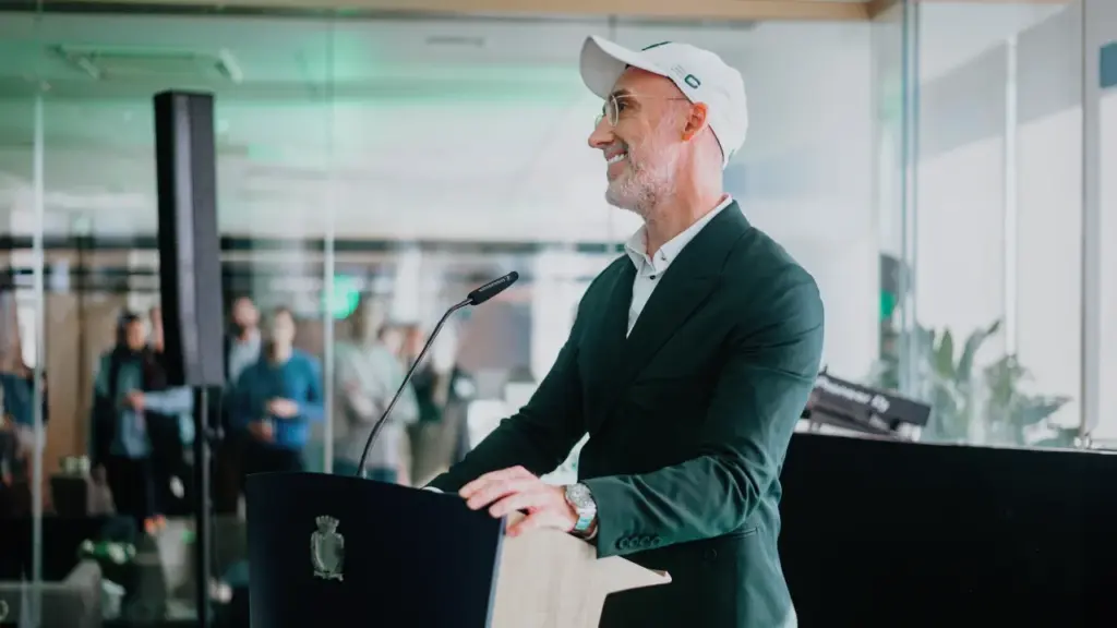 Uri Poliavich speaking at a podium during a professional event